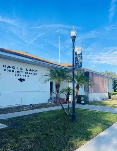 Eagle Lake City Hall, a white building with a flag pole